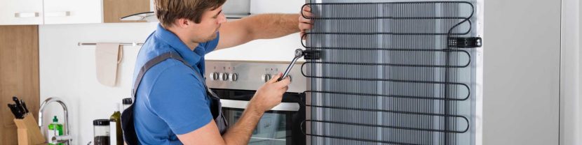 Appliance repair technician working on a machine